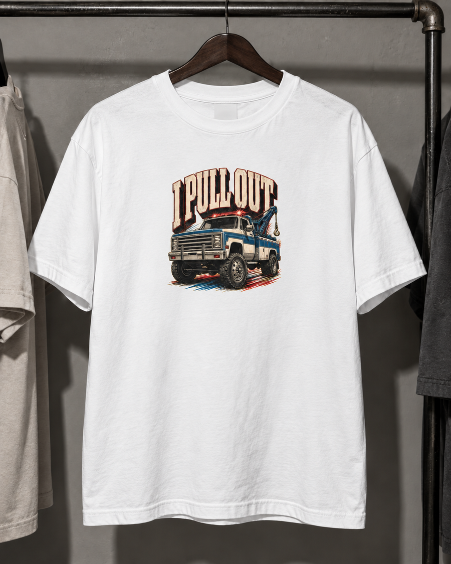 White Pull Out tow-truck graphic tee hanging on a wooden hanger.